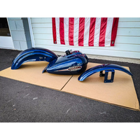 A set of dark blue motorcycle fenders and a fuel tank.