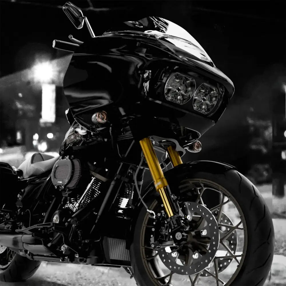 Black motorcycle with gold forks.