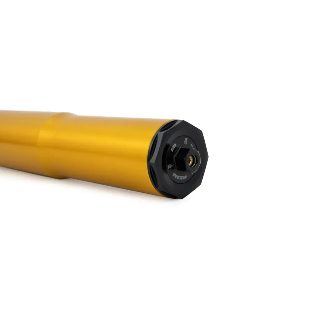 Gold-colored motorcycle fork with black adjustment cap.